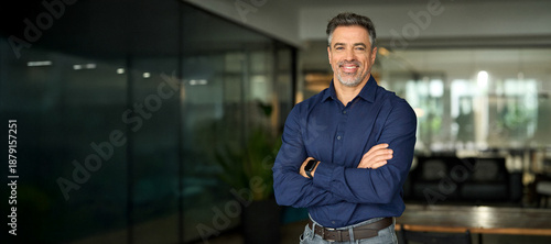 Smiling mature 50 years old business owner, company manager, smiling senior ceo executive, older corporate leader at work. Happy professional business man of middle age standing in office. Portrait.