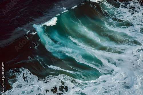 Aerial view of powerful ocean wave crashing with white foam