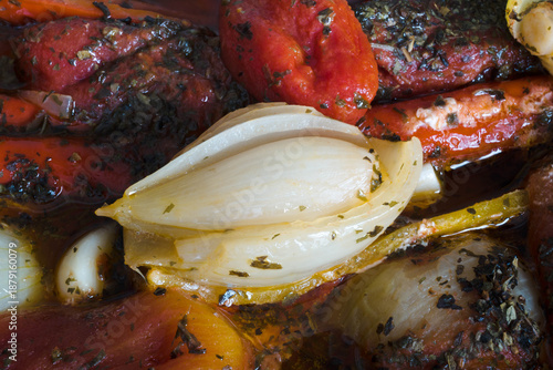 Meal preparation. Cooked vegetables in their own juices, peppers, onions, tomatoes, garlic, basil.
