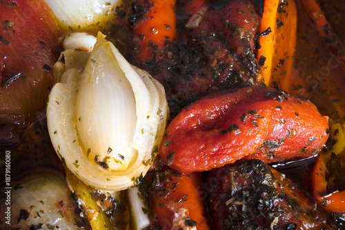 Meal preparation. Cooked vegetables in their own juices, peppers, onions, tomatoes, garlic, basil.

