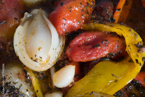 Meal preparation. Cooked vegetables in their own juices, peppers, onions, tomatoes, garlic, basil.
