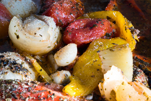 Meal preparation. Cooked vegetables in their own juices, peppers, onions, tomatoes, garlic, basil.
