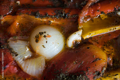 Meal preparation. Cooked vegetables in their own juices, peppers, onions, tomatoes, garlic, basil.
