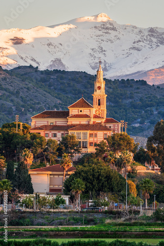 Santuario Nuestra Señora de la Cabeza church in Motril with snow-covered Sierra Nevada mountains in the background, Granada, Spain