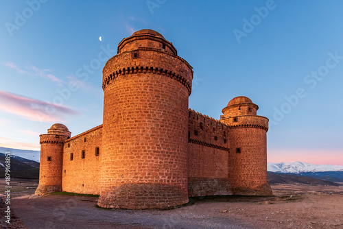 La Calahorra Castle with snow covered Sierra Nevada mountains in the background, Granada, Spain