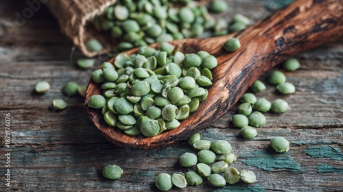 Green Split Peas in Wooden Spoon on Rustic Surface 