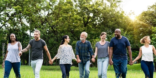 Obraz na plátně Diverse group of friends hold hands at park
