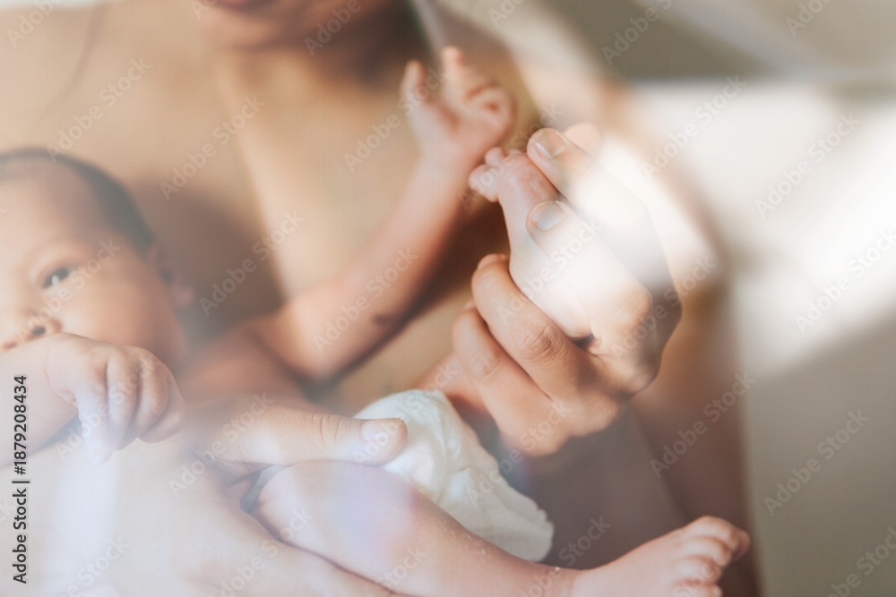 Naklejka premium Mother holding her infant baby