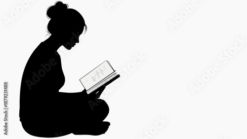 Woman sitting cross-legged reading a book in quiet contemplation