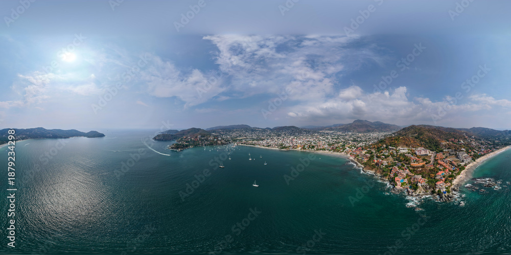 Fototapeta premium 360 Aerial view of Ixtapa Zihuatanejo beach, Costa Grande of Guerrero. Coastal landscape with hotels and crystal clear sea. Zihuatanejo, Guerrero, Mexico.