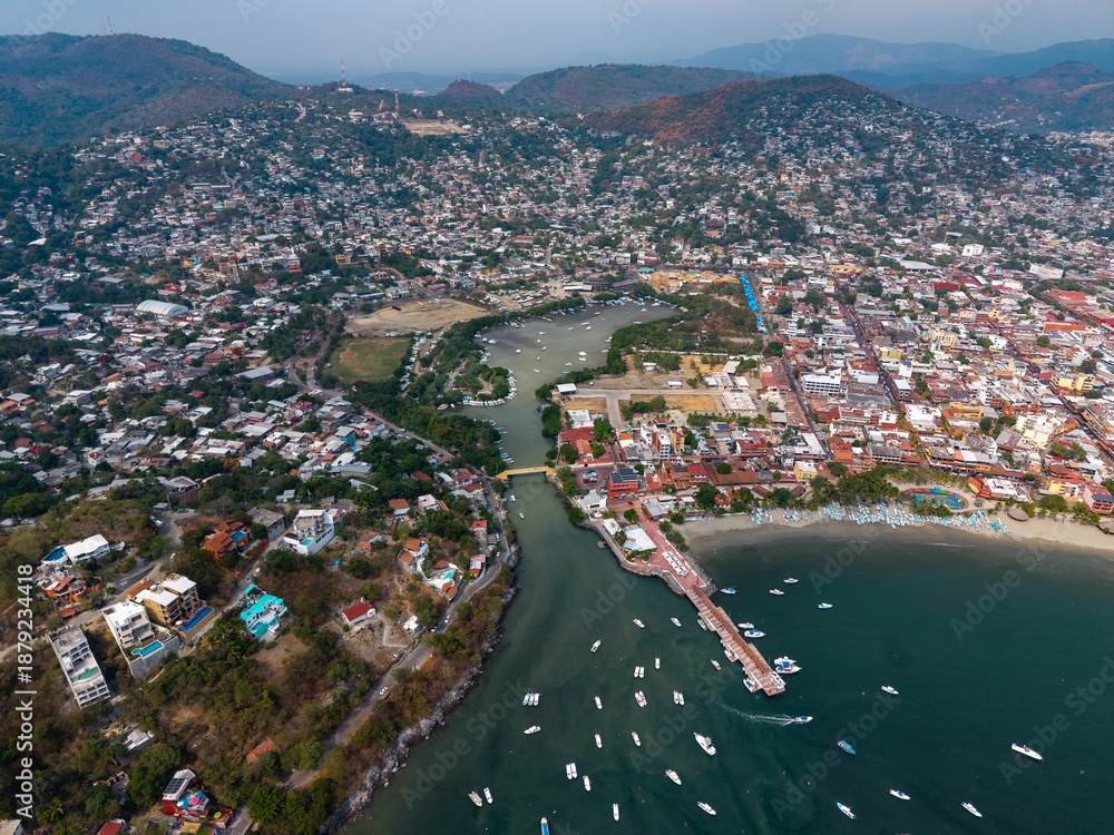 Fototapeta premium Aerial view of the port and bay of Zihuatanejo in Costa Grande, Guerrero. Boats and tourist pier. Zihuatanejo, Guerrero, Mexico. Ixtapa