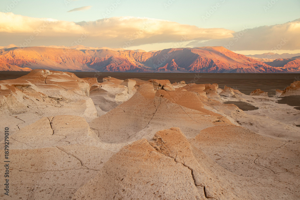 Fototapeta premium Pumice Stone Field Landscape with Mountains at Sunset in Catamarca, Argentina