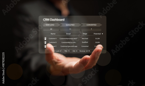 Businessman hand holding CRM dashboard interface with lead management and sales data. Modern customer relationship management concept and software solution for digital marketing and analytics.