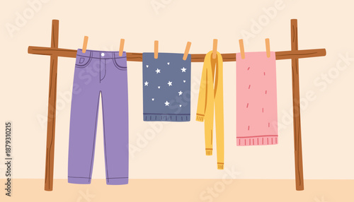 Colorful clothing hanging on a clothesline against a pastel background  