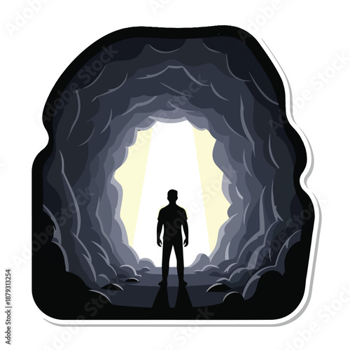 A man stands at the entrance of a cave with light