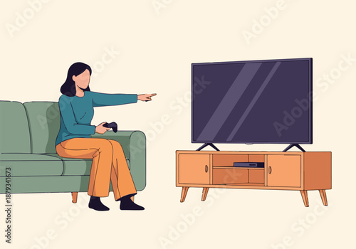 Young woman playing video games on a sofa in a modern living room