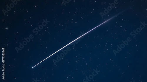 A brilliant meteor streak with a glowing tail in a star-filled night sky.