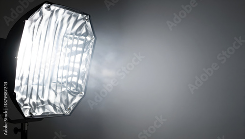 Illuminating Radiance: A professional studio light fixture directs a beam of pristine, diffused illumination, symbolizing focused attention and the art of professional lighting.