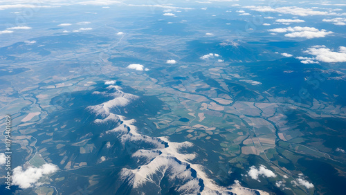 Aerial view of mountains and clouds from airplane window