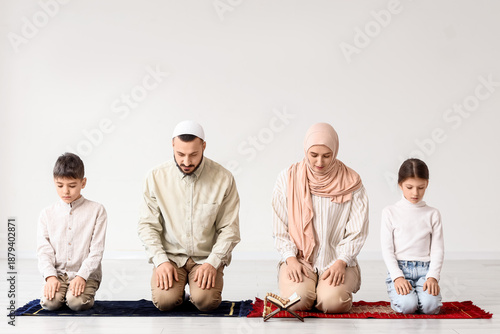 Muslim family praying near ...