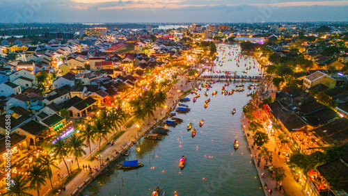 Fotografie Dramatic aerial vista of the ancient town of Hoi An, Vietnam, illuminating at dusk