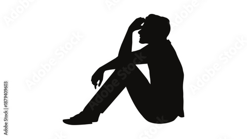 A black silhouette of a person sitting on the floor with their head down, conveying feelings of sadness or loneliness.