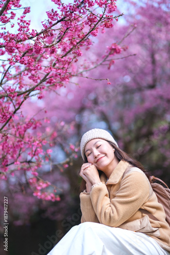 Wallpaper Mural Portrait image of a woman with closed eyes among the pink Sakura flower in the park Torontodigital.ca