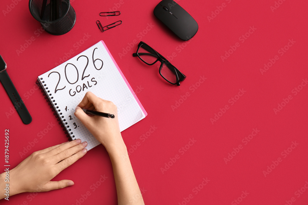 Naklejka premium Woman with computer mouse writing goals on 2026 against red background