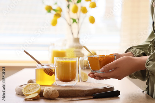Woman making turmeric drink...