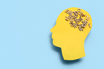 Paper human head with music notes on blue background. World Mental Health Day