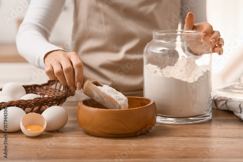 Woman preparing dough with ...