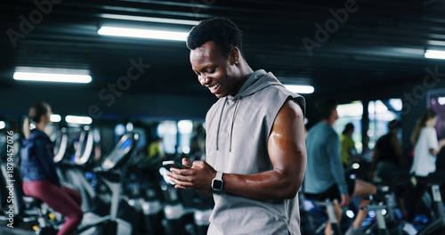 Photos Fitness, man and happy with phone at gym for workout progress, membership renewal and sign up