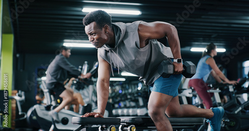 Fitness, weightlifting or black man in center with dumbbell, endurance or bicep training in bodybuilding. Exercise, active or athlete with equipment, intense workout or resilience in muscle gain.