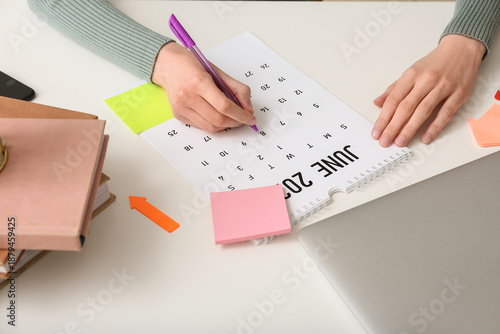 Young woman with laptop mar...