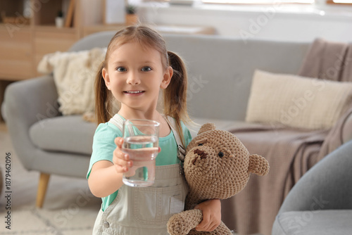 Cute little girl with glass...