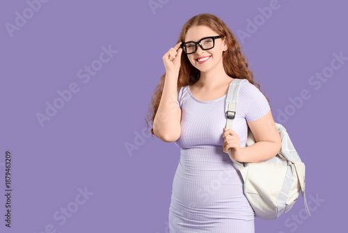 Happy female student with b...