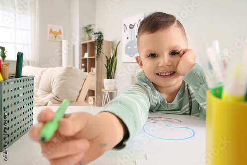 Adorable little boy drawing...