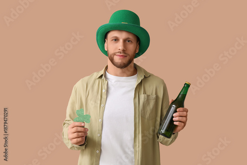 Young man in green hat hold...
