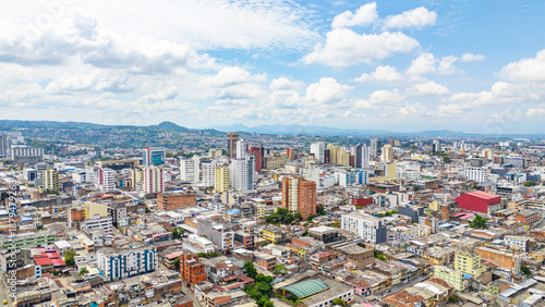 Stunning aerial view of Pereira, Risaralda, showcasing urban landscape and architecture under a bright sky.
