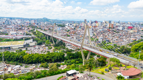 Aerial view of Pereira Bridge connecting urban areas in Pereira, Risaralda, Colombia, showcasing city life amidst greenery.