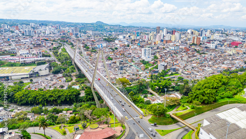 Aerial view of Pereira, Risaralda, Colombia showcasing the Pereira Bridge and urban landscape with lush greenery.