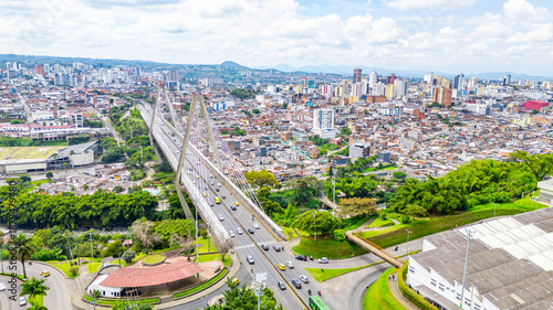 Stunning aerial view of Pereira Bridge connecting the city and lush green areas in Risaralda, Colombia. Urban landscape featuring modern architecture and roads.