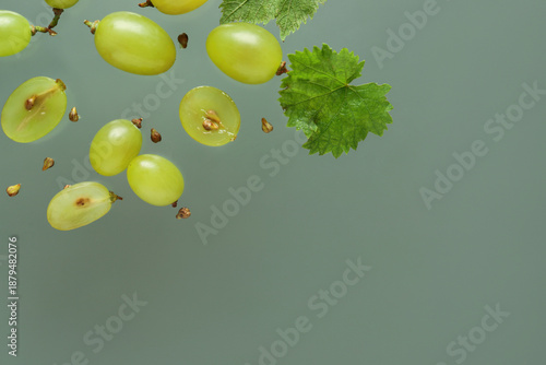 Fresh green grapes with lea...