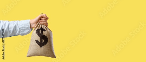 Hand holding burlap sack fu...