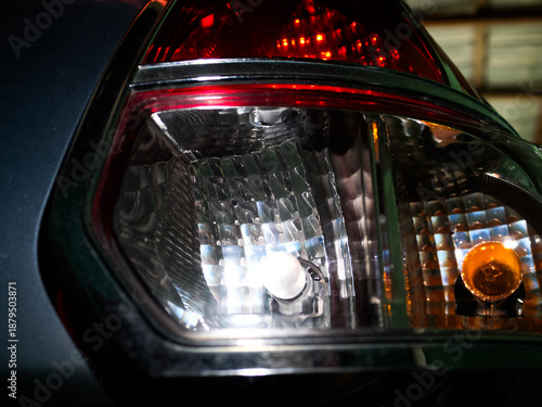 Car rear taillight glowing in low light