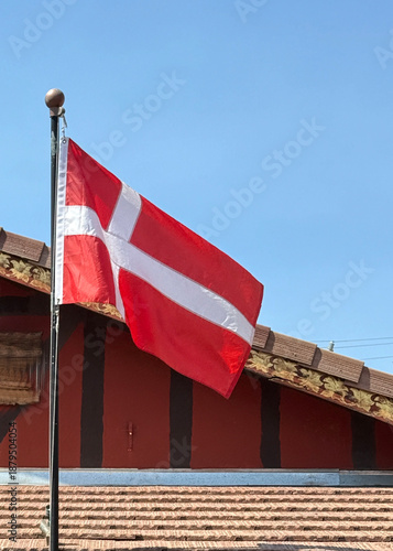 Danish Flag in front of a wooden building