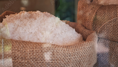 Obraz na płótnie Coarse salt in sacks on the table.
