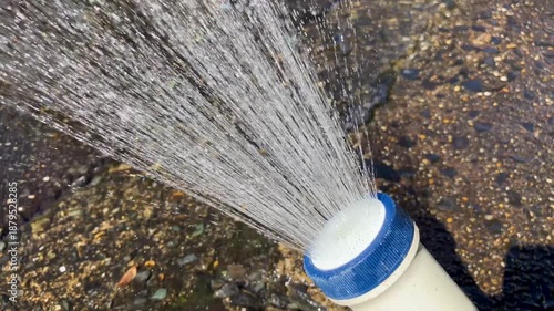 Splashing water from an outdoor shower during the day; Horizontal; Video