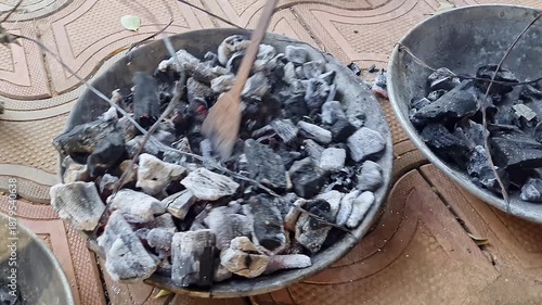 closeup of burned charcoal with benzoin or frankincense transferred to different pan