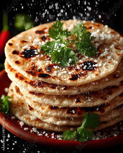 Stack of Delicious Paratha Flatbreads with Fresh Herbs and Sprinkled Salt.